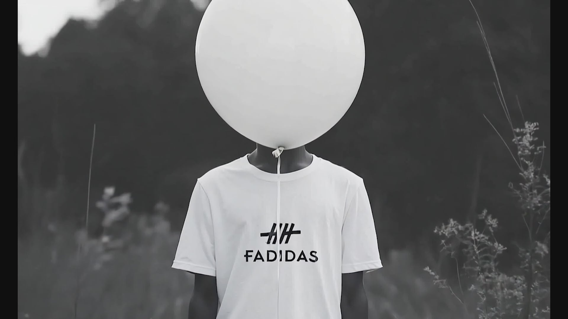 Load video: Fadidas brand story video: Artists creating vibrant designs, printing process on high-quality t-shirts, models showcasing unique wearable art pieces in urban settings. Ends with Fadidas logo and tagline &#39;Wear Your Creativity